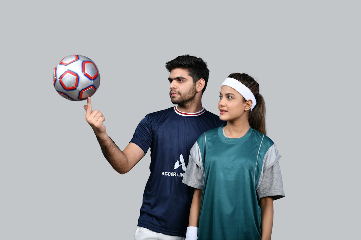 a man and a woman holding a ball